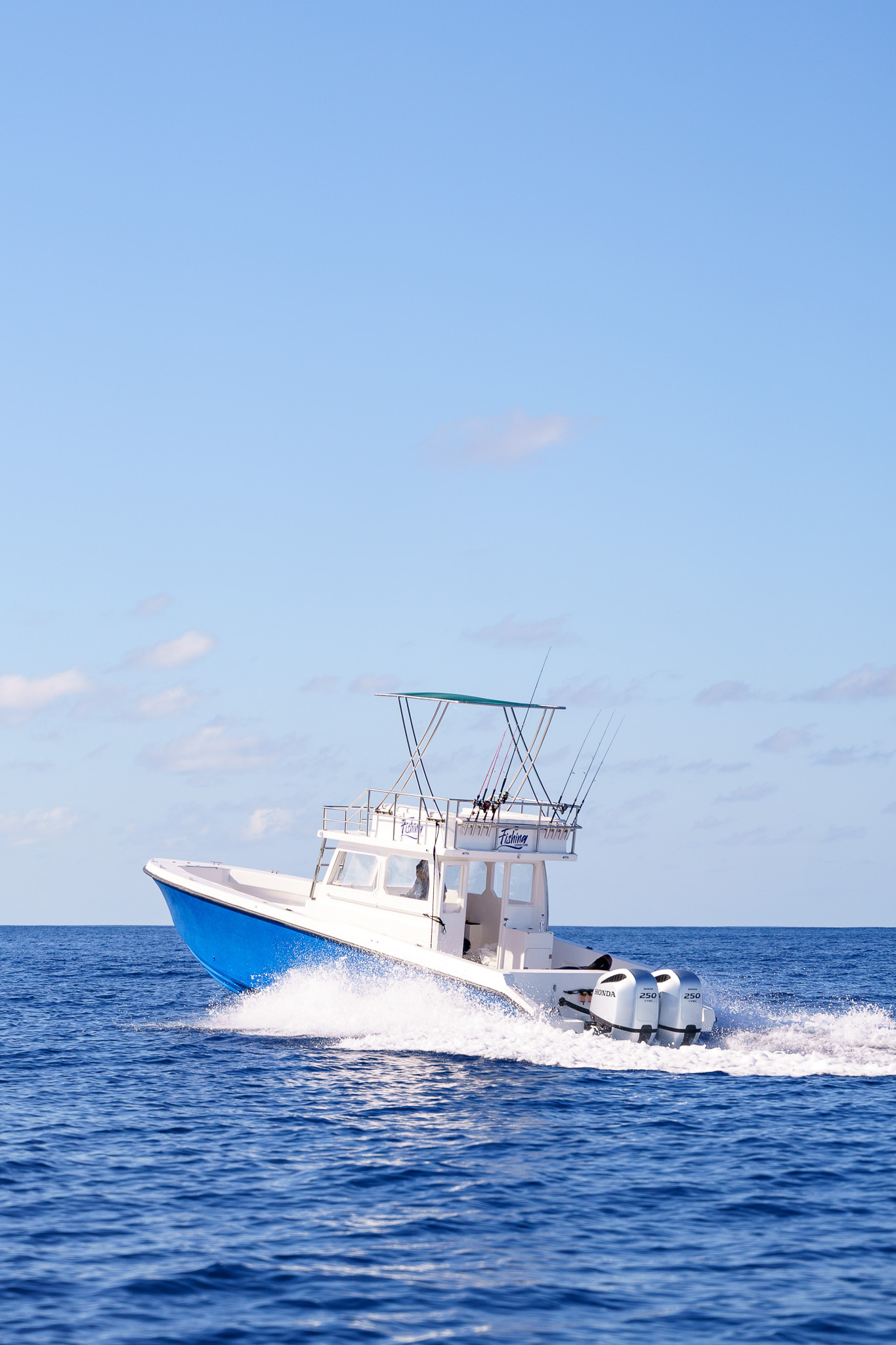 Offshore vessel stern view showing twin engines at speed